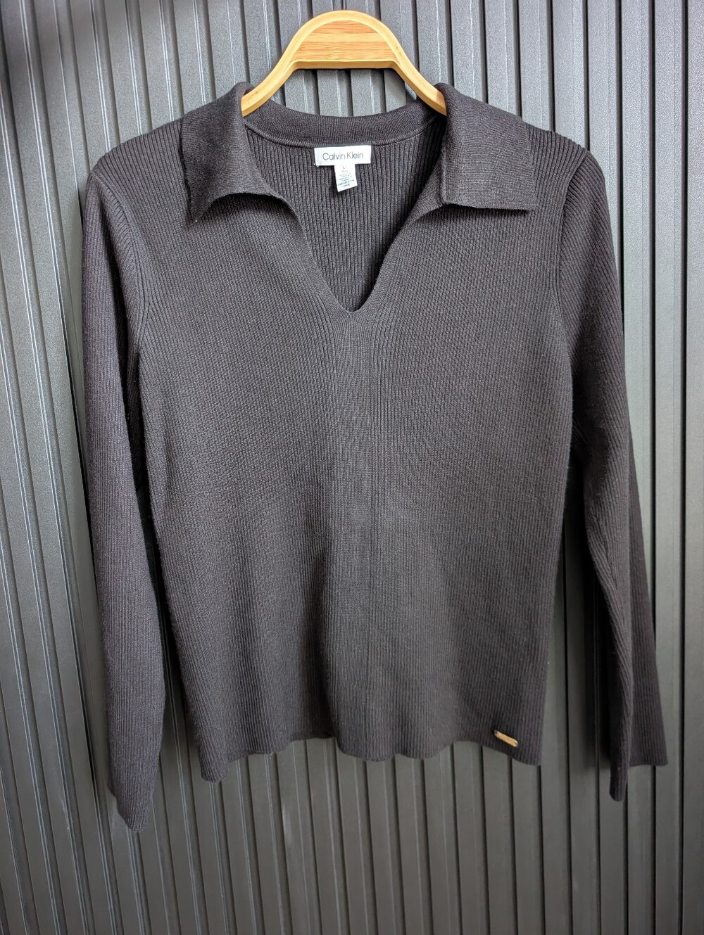 Calvin Klein black ribbed-knit polo sweater with a V-neck and collar